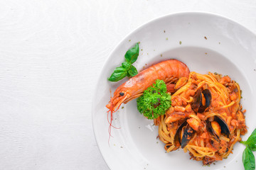 Seafood Pasta. Mussels, shrimp. On a wooden background. Top view. Free space for your text.