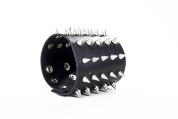 Punk bracelet with spike spikes closeup texture studio photo.