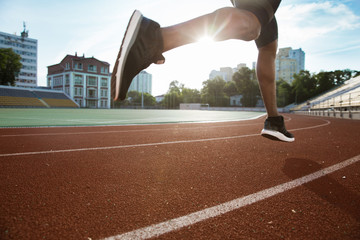Cropped image of sportsman's legs running