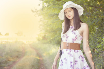 Beautiful young girl in a summer field