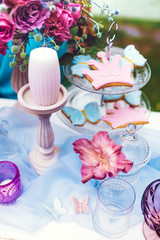 Decoration from flowers and cookies on the white table. Wedding, party decor.