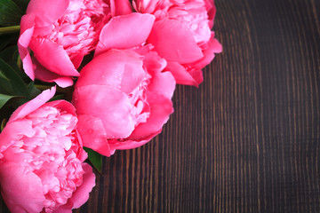 Pink peonies on a wooden table. Beautiful floral background.