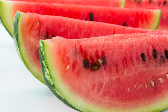 Slices of red  watermelon. Closeup. White background.