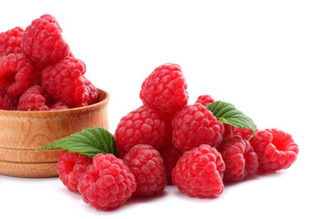 ripe raspberries in wooden bowl isolated on white background close up