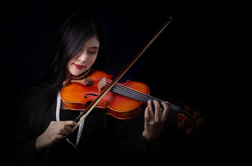 Playing the violin. Musical instrument with hands on dark background. - 165729888