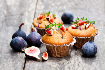 Baked  muffins with figs on rustic wooden table