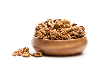 Walnut  kernels in a wooden bowl isolated on white