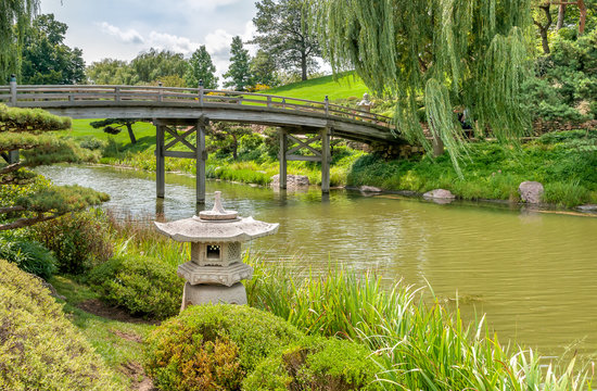 Bridge to Japanese Garden area with Japanese style stone lantern in front in Chicago Botanic Garden, USA
