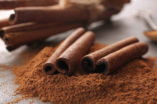 Closeup view of cinnamon sticks and powder on table