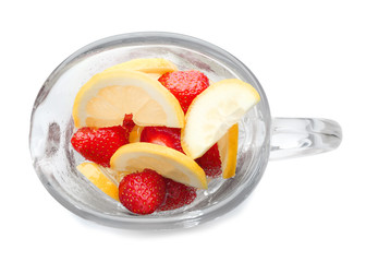 Glass jug with tasty strawberry lemonade on white background