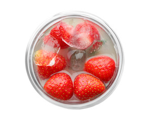 Glass of tasty strawberry lemonade on white background