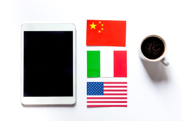 Self-education. Learning languages online. Headphones and tablet PC on white table background top view mockup