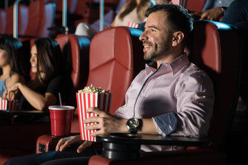 Happy guy watching a movie