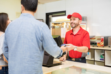 Worker selling some food at the movies © AntonioDiaz