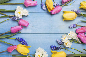 Frame from pink,  yellow tulips and  white daffodils flowers