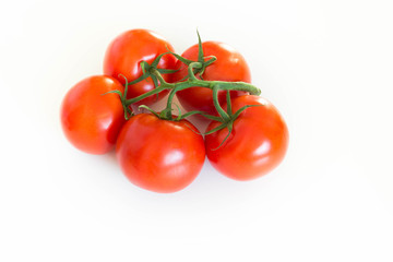 Bunch of fresh tomatoes on a twig, over white background