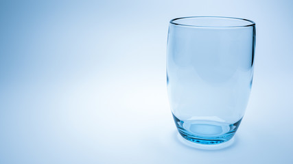 3d render of empty water glass on right with blue light