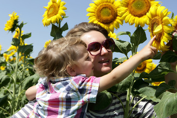 Mother and son looking at sunflowers