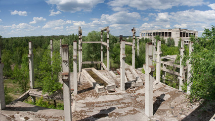 Abandoned overgrown industrial ruins