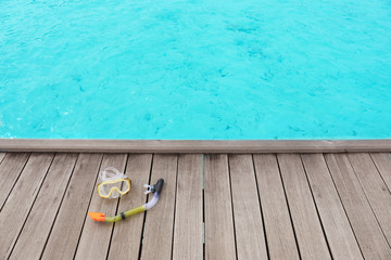 Accessories for snorkeling on wooden pontoon at sea resort. Summer vacation concept