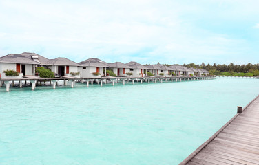 View of modern beach houses on piles at tropical resort