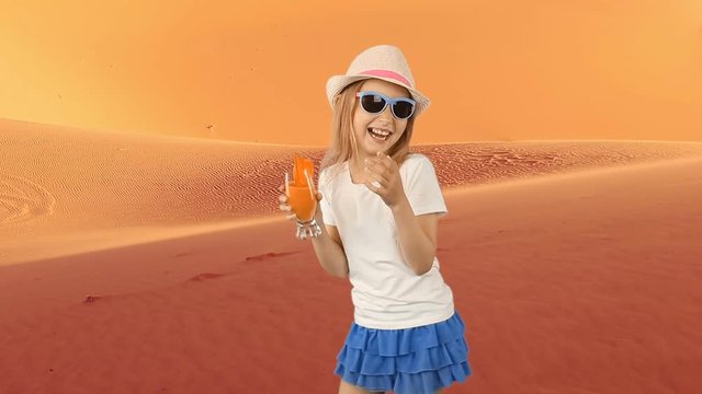 Young caucasian girl drink orange juice. Young girl in sahara desert feeling thirst. Very hot warm climat in desert. Fresh juice of orange fruit drinking walking in hat summer day.
