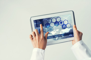 Close of female doctor hands working with tablet pc computer