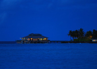 View of modern beach house at tropical resort in evening