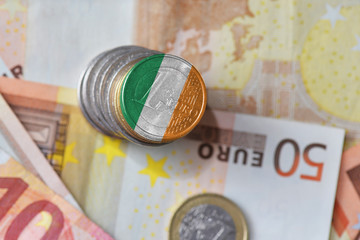 euro coin with national flag of ireland on the euro money banknotes background.