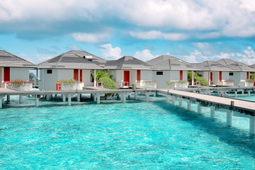Modern beach houses on piles at tropical resort