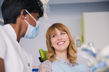 Young blond woman getting dental treatment in clinic