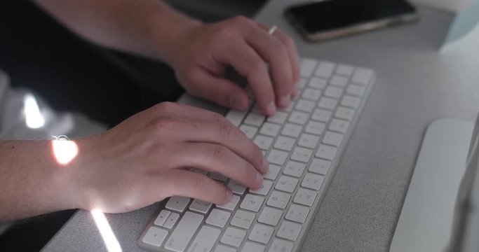 Man using a keyboard in his home office for freelance business.