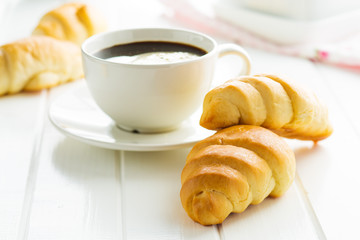 Sweet tasty croissants and coffee cup.