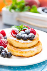 Cottage cheese pancakes, syrniki, curd fritters with berries
