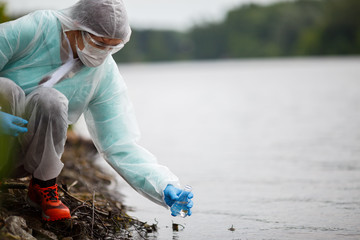 Ecologist takes water for examination