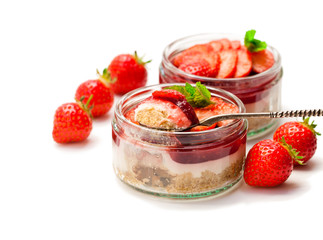Mini  strawberry cheesecake in a glass pots isolated on white background