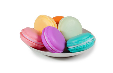 group of colorful macaroons cakes on the plate isolated on white background