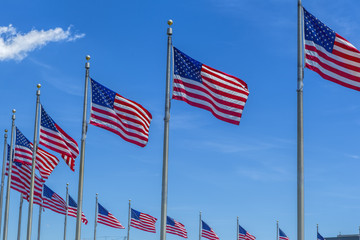 US flags against blue sky.