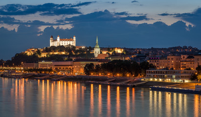 Bratislava castle at night with light reflection on the dunaj river on right riverside. - obrazy, fototapety, plakaty