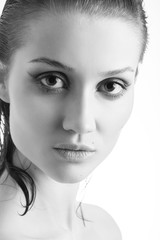 beautiful female portrait with bare shoulders on white background, monochrome