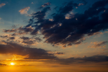 Fototapeta premium Dramatic sunset sunrise sky with dark blue clouds