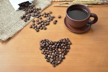 Coffee beans and a cup of coffee on the table