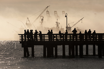 Salmon Fishermen on Elliott Bay in Seattle, Washington. On an early foggy morning on a pier in West...