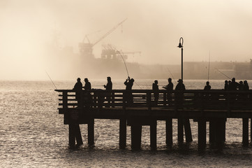 Salmon Fishermen on Elliott Bay in Seattle, Washington. On an early foggy morning on a pier in West...