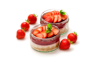 Mini  strawberry cheesecake in a glass pots isolated on white background