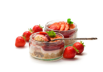 Mini  strawberry cheesecake in a glass pot isolated on white background