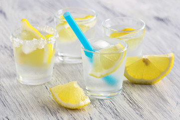 Cold drink with lemon slice and ice.