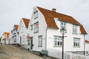Street with white painted wooden houses in the old part of Stavanger, Norway.