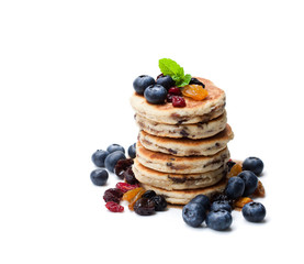 Stack  of welsh cakes with dry berries and fresh blueberries isolated on white