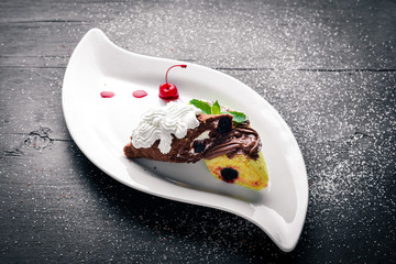 Chocolate creamy cream sponge. On a wooden background. Top view. Free space for text.